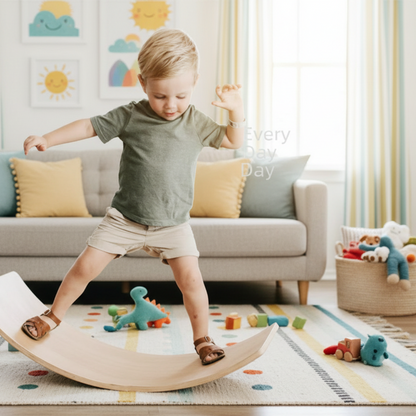 Child balancing on a wooden wobble board with a chalkboard in the background