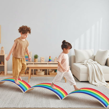 Two children playing on a rainbow-shaped balance board in a room with a teepee and toys.