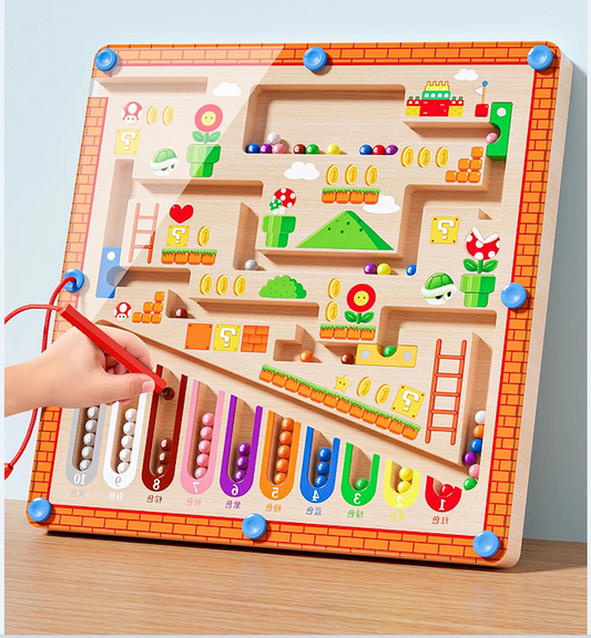 Wooden maze toy with colorful elements and a hand using a red tool to interact with it.
